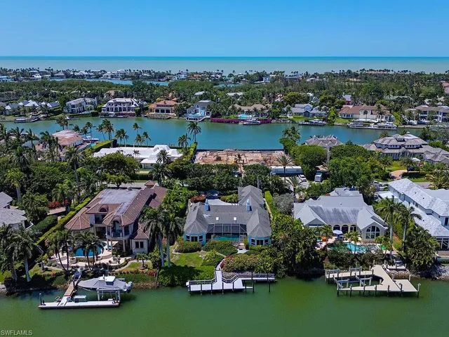 an aerial view of a house with a garden and lake view