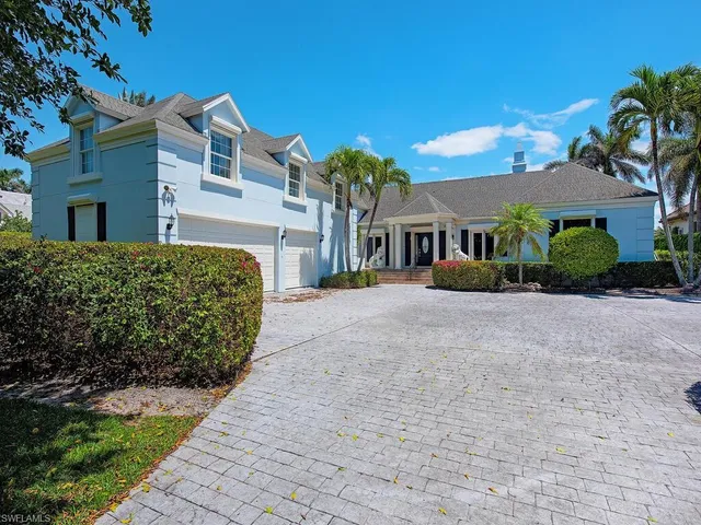a front view of a residential houses with yard