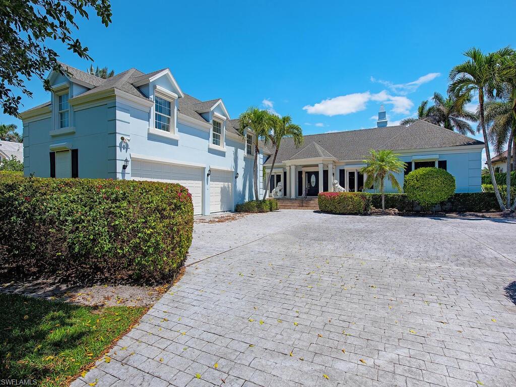 3495 Gin Lane Naples, FL 34102 - Photo 7 of 18 a front view of a residential houses with yard
