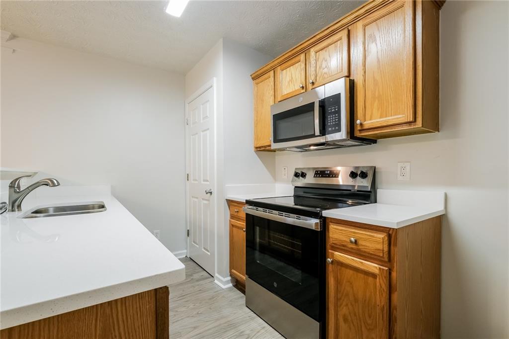 4011 Riverside Parkway Decatur, GA 30034 - Photo 12 of 27 a kitchen with stainless steel appliances granite countertop a sink stove and microwave