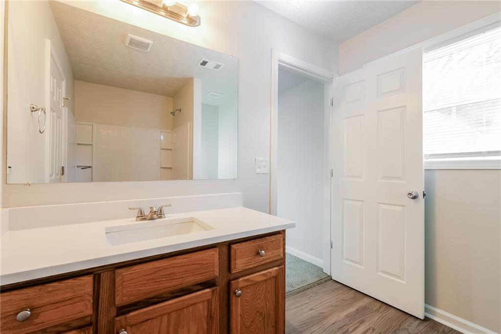 4011 Riverside Parkway Decatur, GA 30034 - Photo 17 of 27 a bathroom with a sink a mirror and a shower