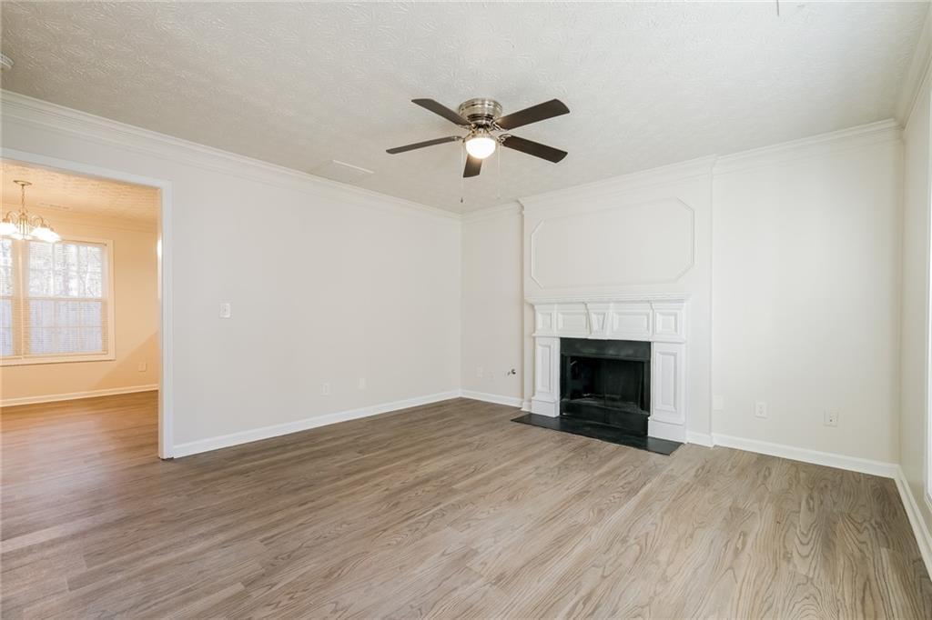 4011 Riverside Parkway Decatur, GA 30034 - Photo 6 of 27 an empty room with wooden floor a fireplace and windows
