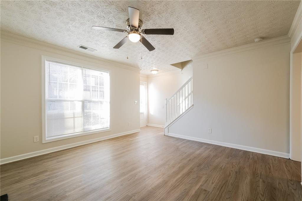 4011 Riverside Parkway Decatur, GA 30034 - Photo 8 of 27 an empty room with wooden floor fan and windows