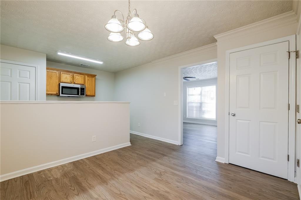4011 Riverside Parkway Decatur, GA 30034 - Photo 10 of 27 a view of a room with wooden floor and chandelier