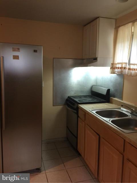 10327 Royal Road Silver Spring, MD 20903 - Photo 3 of 14 a kitchen with a stove and a refrigerator
