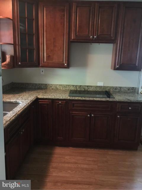 10327 Royal Road Silver Spring, MD 20903 - Photo 7 of 14 a kitchen with granite countertop wooden cabinets