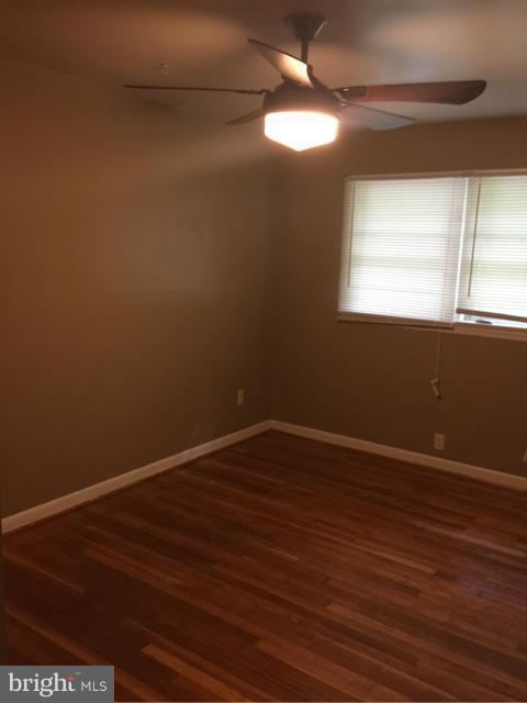 10327 Royal Road Silver Spring, MD 20903 - Photo 10 of 14 a view of an empty room with wooden floor and a window
