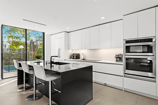 a kitchen with stainless steel appliances a sink a stove and a refrigerator