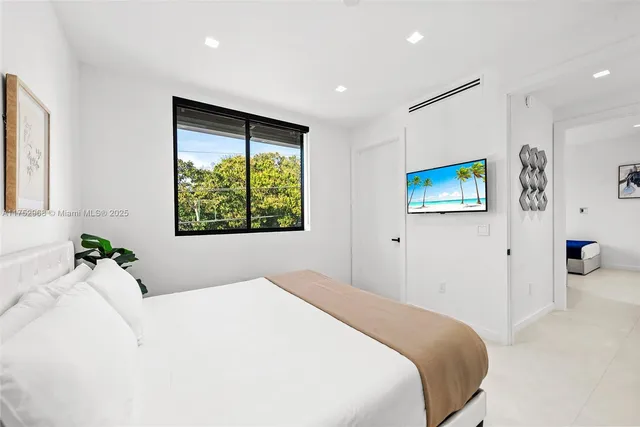 a bathroom with a toilet sink vanity and shower