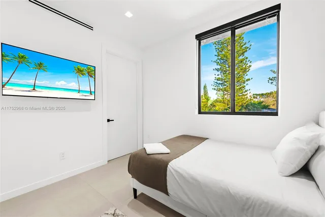 a view of a patio with table and chairs and couches with wooden floor and fence