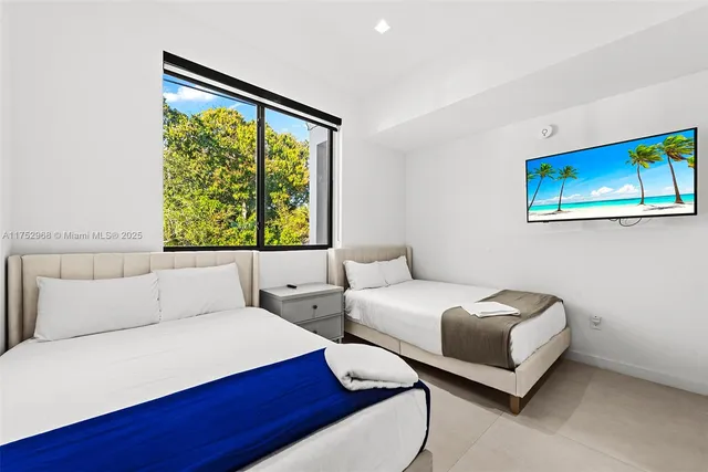 a view of a patio with table and chairs under an umbrella