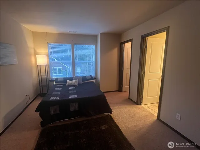 a bathroom with a double vanity sink toilet mirror and shower