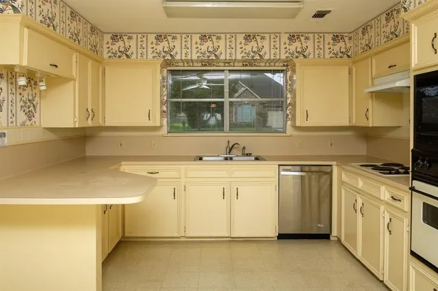 a kitchen with white cabinets and white appliances