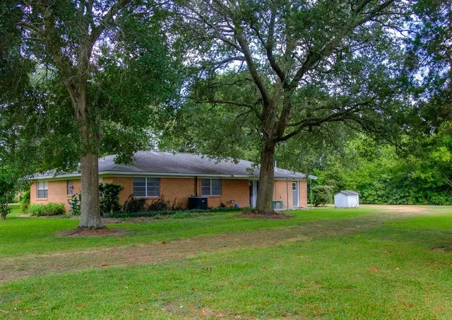 a front view of a house with a yard porch and green space