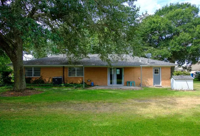 a view of a house with a yard and sitting area