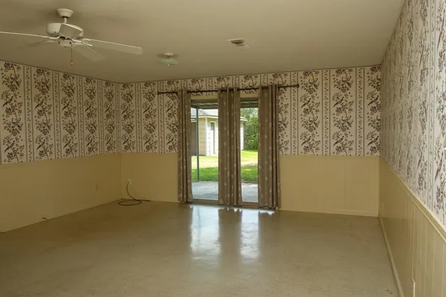 a view of a livingroom with wooden floor and a window