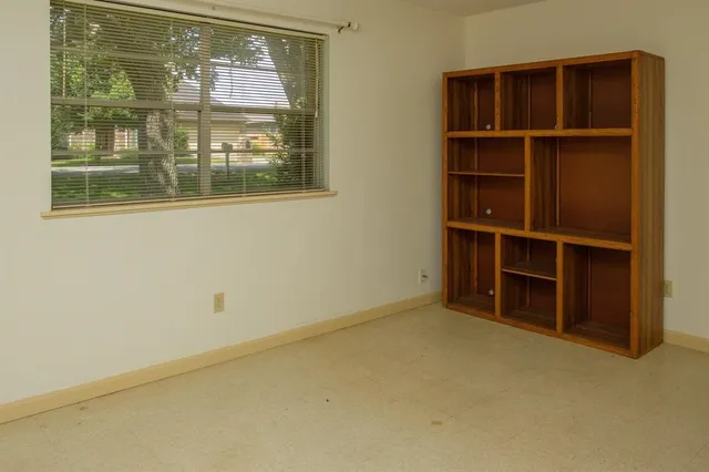 a view of an empty room with a window