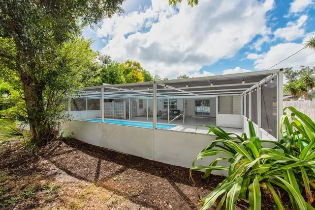a front view of house with a garden