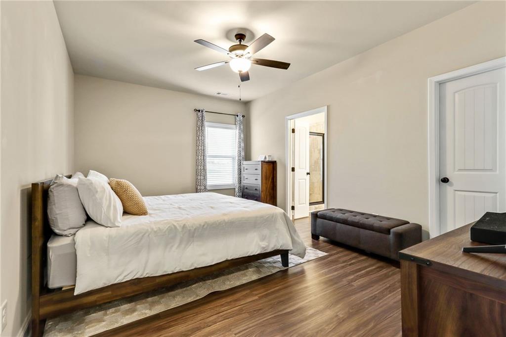 391 Mulberry Rock Road Temple, GA 30179 - Photo 13 of 25 a bedroom with a bed and a chandelier