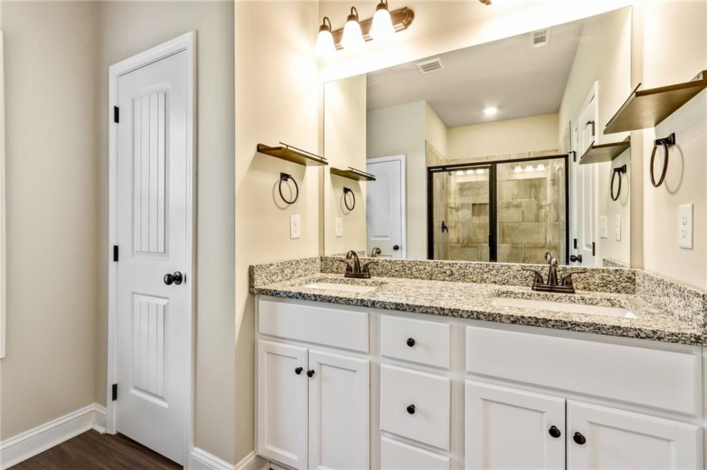 391 Mulberry Rock Road Temple, GA 30179 - Photo 15 of 25 a bathroom with a granite countertop sink and a mirror