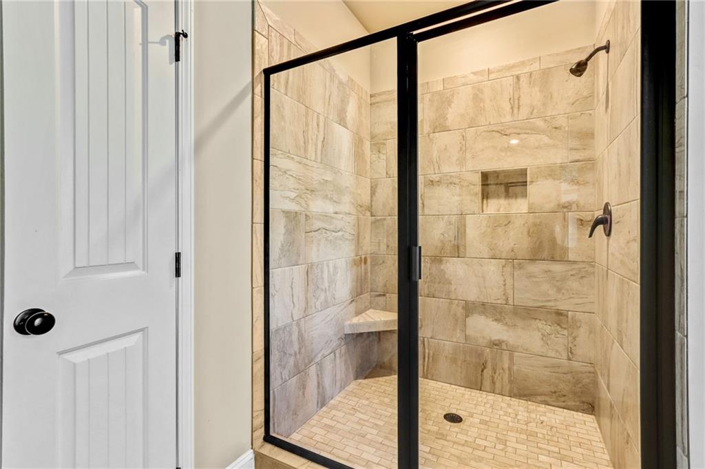 391 Mulberry Rock Road Temple, GA 30179 - Photo 16 of 25 a bathroom with a glass shower door
