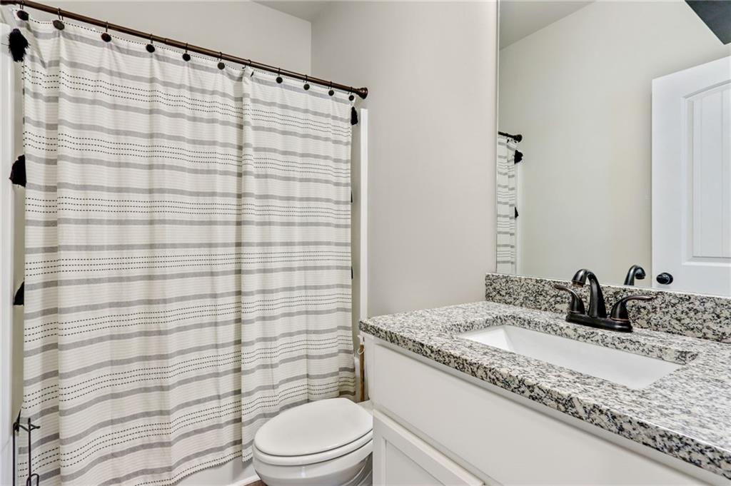 391 Mulberry Rock Road Temple, GA 30179 - Photo 19 of 25 a bathroom with a granite countertop sink toilet and shower