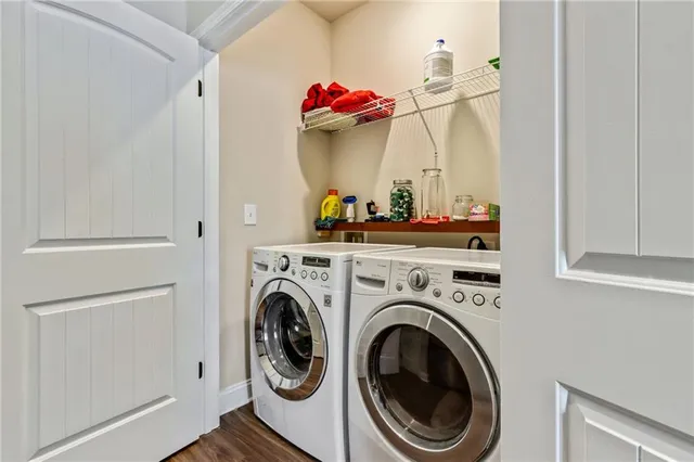 a view of a storage and utility room with washer and dryer