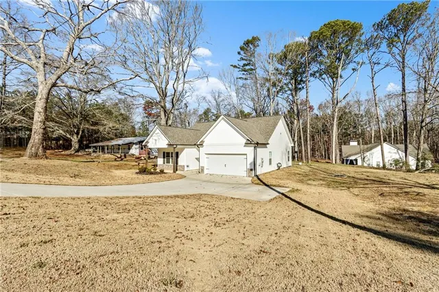 a view of the house with snow on the road