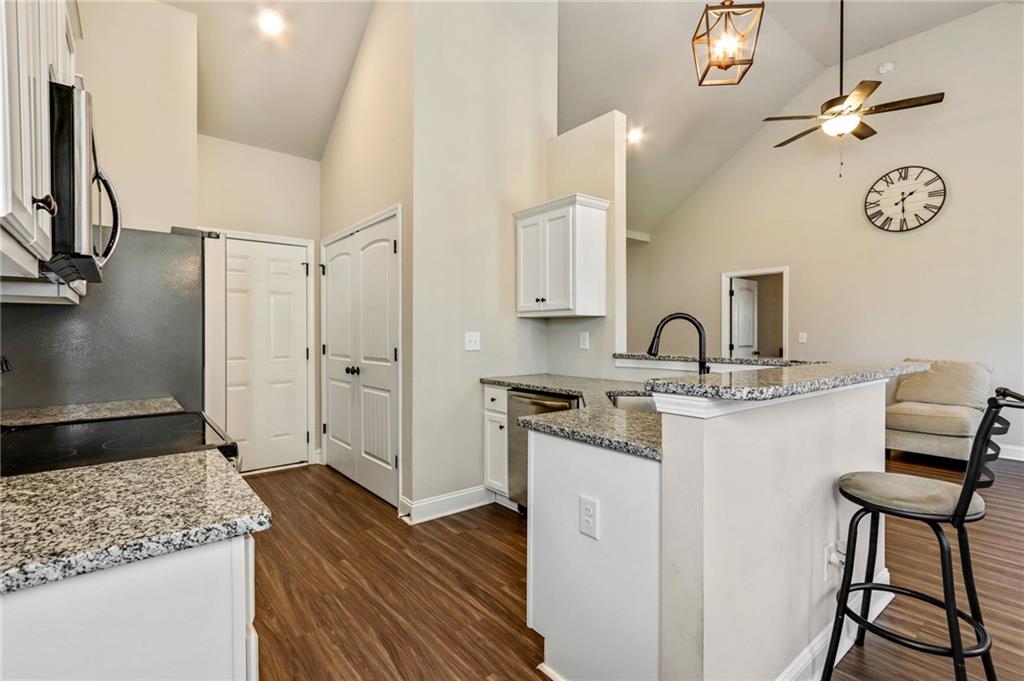 391 Mulberry Rock Road Temple, GA 30179 - Photo 9 of 25 a kitchen with stainless steel appliances granite countertop a sink stove and refrigerator