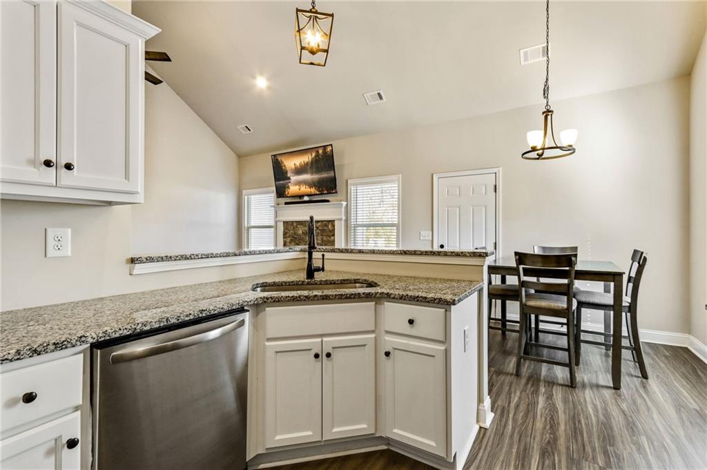 391 Mulberry Rock Road Temple, GA 30179 - Photo 10 of 25 a kitchen with stainless steel appliances granite countertop a sink a stove and white cabinets