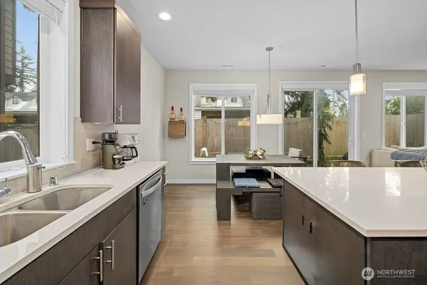 a kitchen with counter top space appliances and windows
