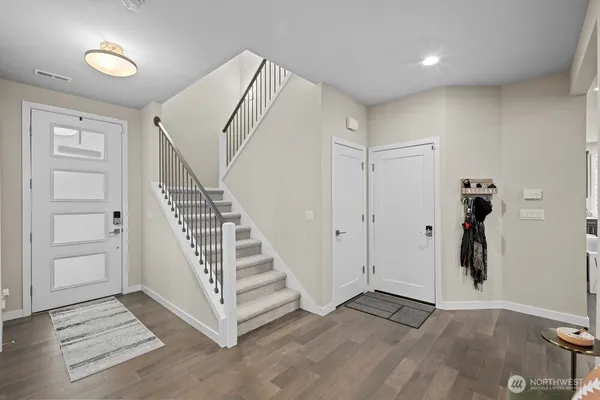 a view of entryway with wooden floor and stairs
