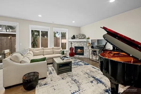 a living room with furniture a fireplace and a flat screen tv