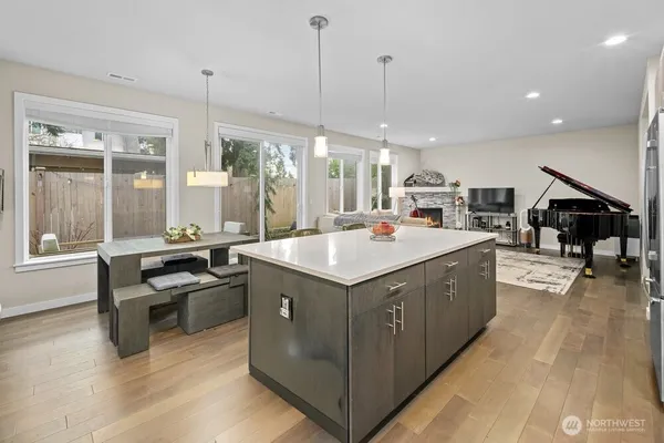 a kitchen with stainless steel appliances granite countertop a sink and a wooden floors