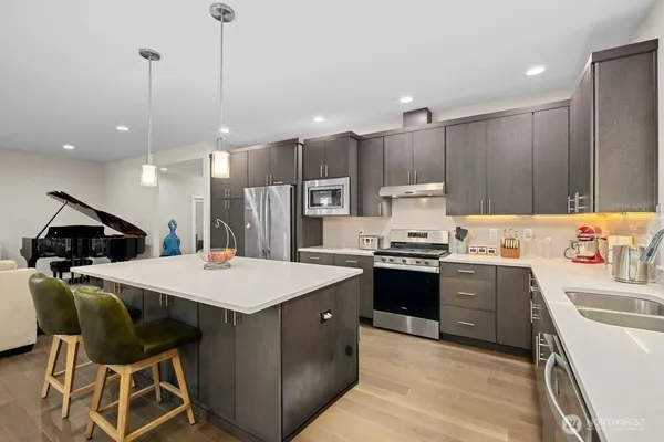a kitchen with a stove a sink and a refrigerator