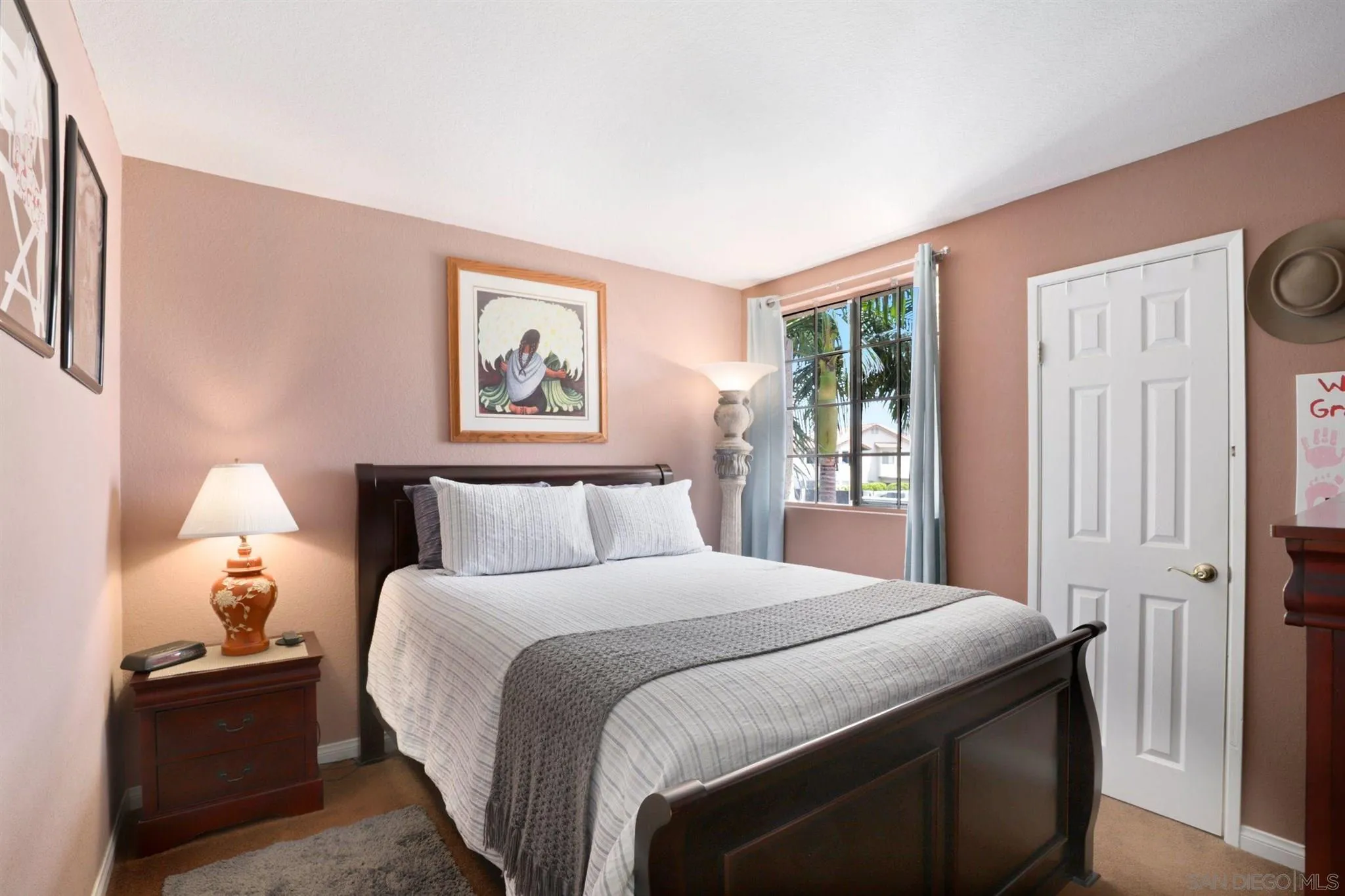 910 Redbud Road Chula Vista, CA 91910 - Photo 17 of 33 a bedroom with a bed and a lamp with window