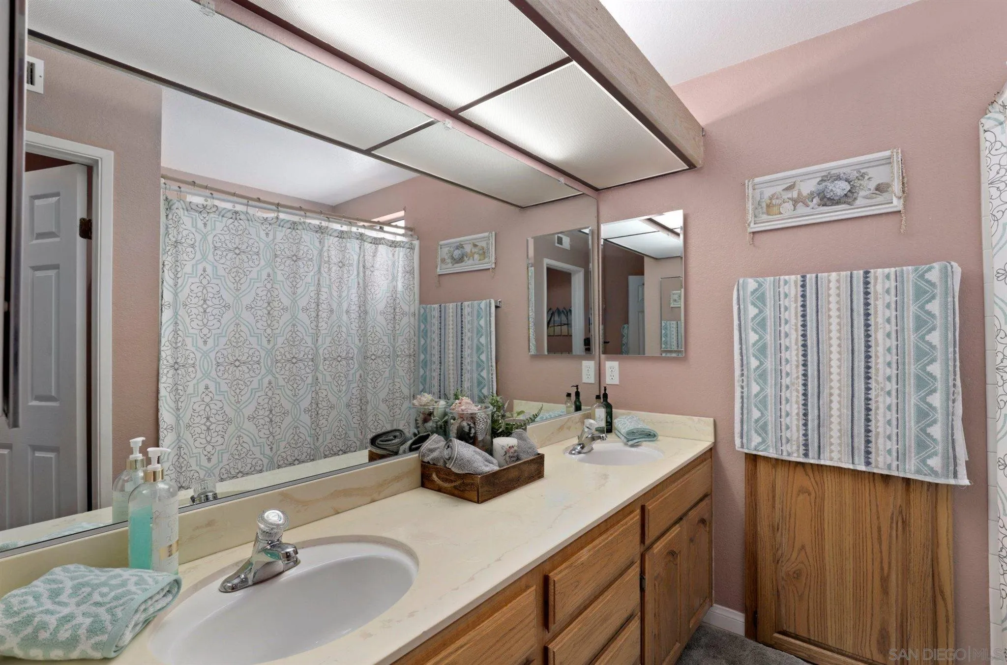 910 Redbud Road Chula Vista, CA 91910 - Photo 20 of 33 a bathroom with a granite countertop sink mirror and double