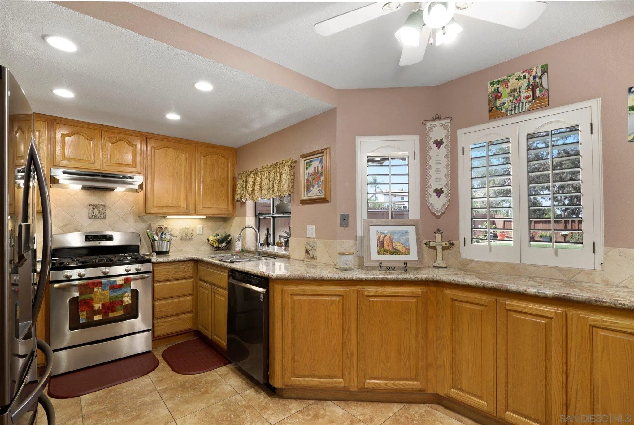 910 Redbud Road Chula Vista, CA 91910 - Photo 9 of 33 a kitchen with stainless steel appliances granite countertop a stove a sink and a refrigerator