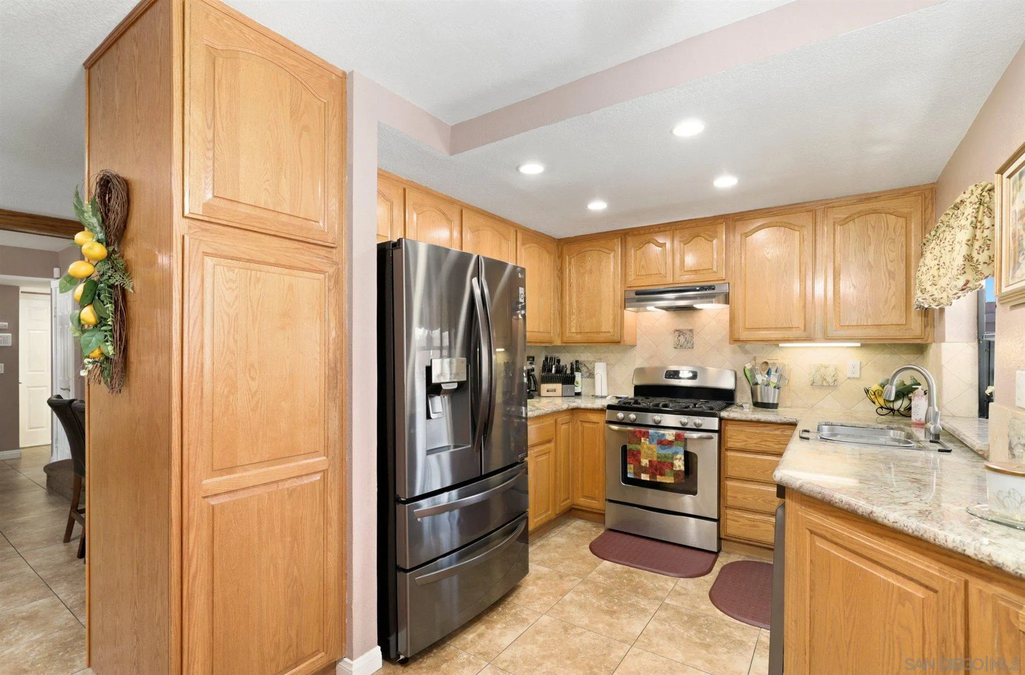 910 Redbud Road Chula Vista, CA 91910 - Photo 10 of 33 a kitchen with stainless steel appliances granite countertop a refrigerator stove and sink