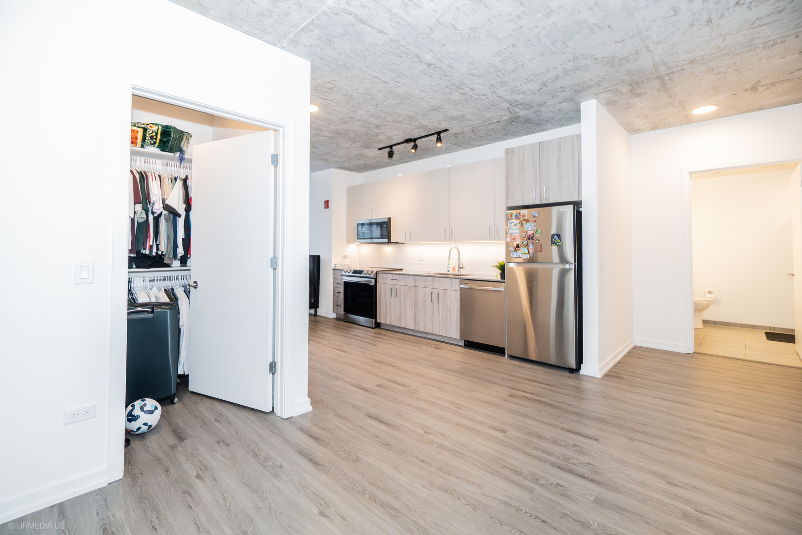 808 North Cleveland Avenue, Unit 1608 Chicago, IL 60610 - Photo 7 of 20 a view of a kitchen with refrigerator and wooden floor
