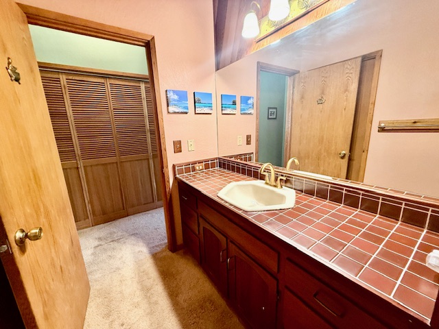 11-3763 10th Street Volcano, HI 96785 - Photo 18 of 28 a bathroom with a sink and a mirror