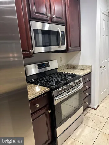a stove top oven sitting inside of a kitchen