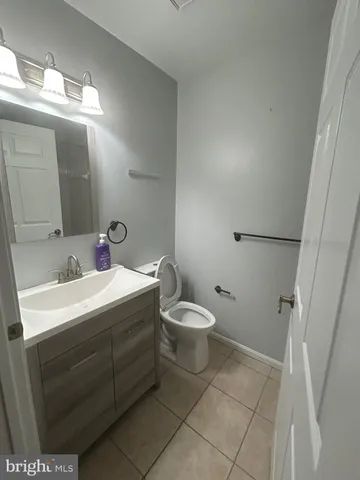 a bathroom with a sink toilet and mirror