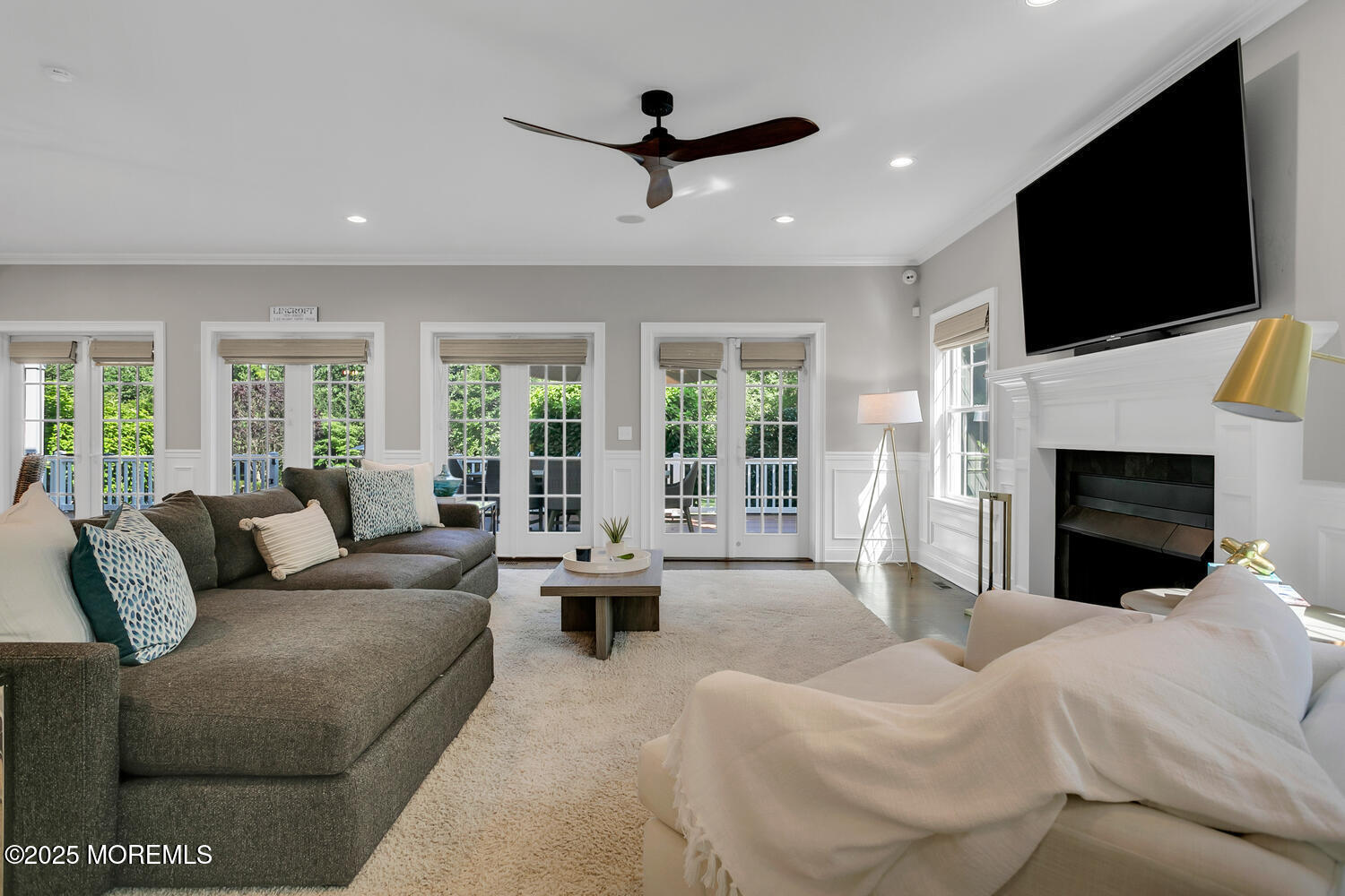 19 Old Phalanx Road Lincroft, NJ 07738 - Photo 12 of 34 a living room with furniture a fireplace and a flat screen tv