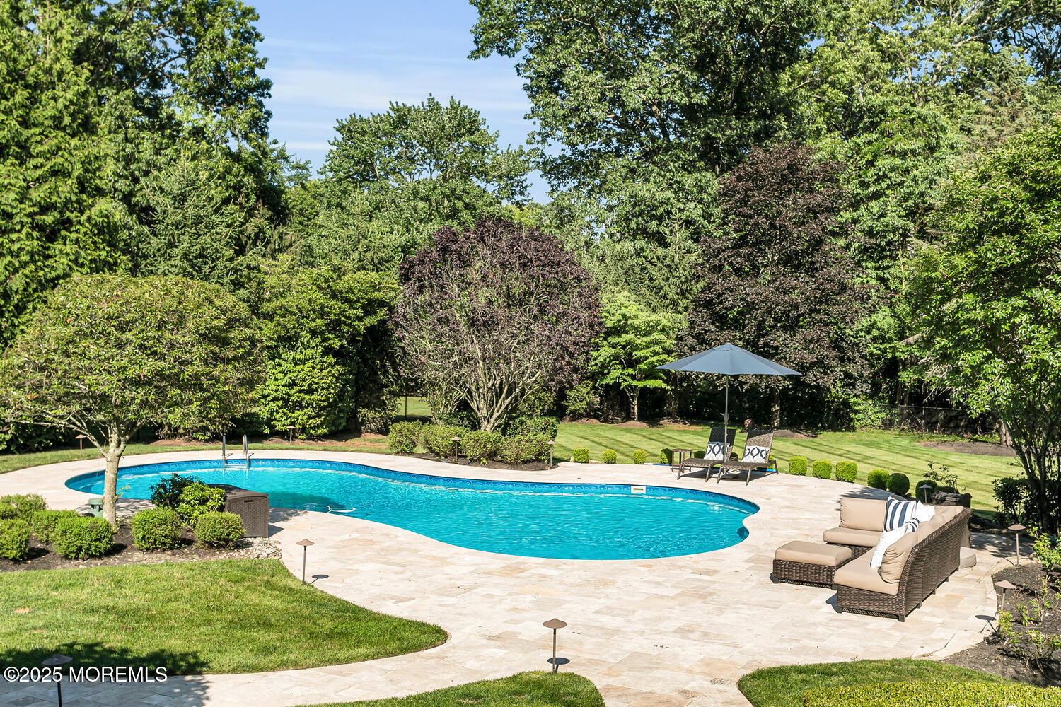 19 Old Phalanx Road Lincroft, NJ 07738 - Photo 3 of 34 a view of a swimming pool with a patio