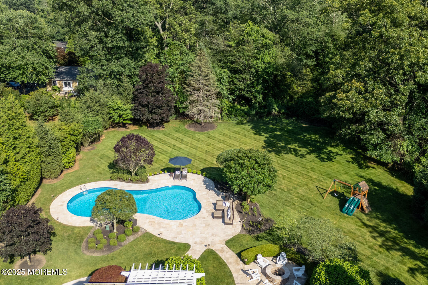 19 Old Phalanx Road Lincroft, NJ 07738 - Photo 32 of 34 a backyard of a house with a yard and outdoor seating