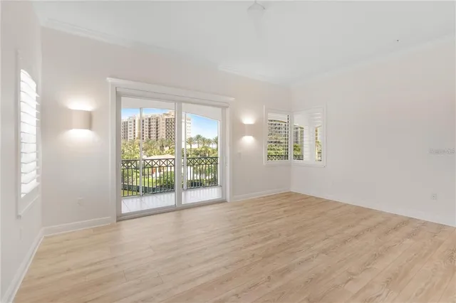 an empty room with windows and closet