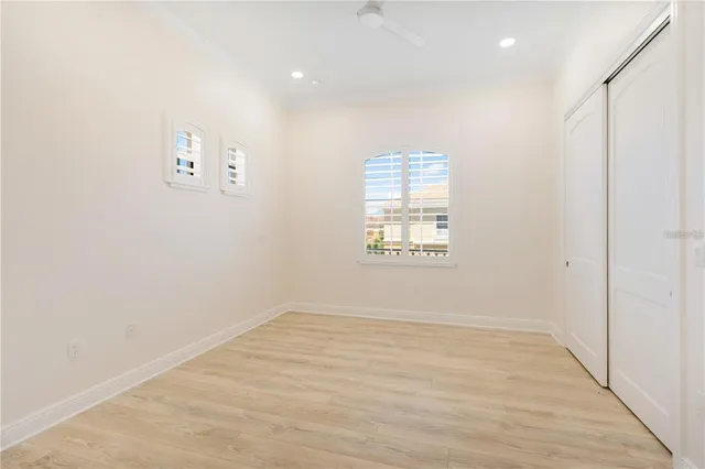 a view of empty room with wooden floor