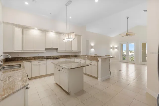 a kitchen with refrigerator and cabinets