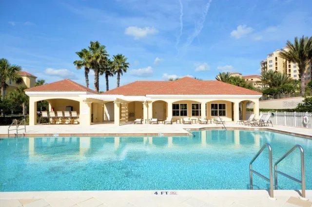 an aerial view of a house with swimming pool garden view and lake view